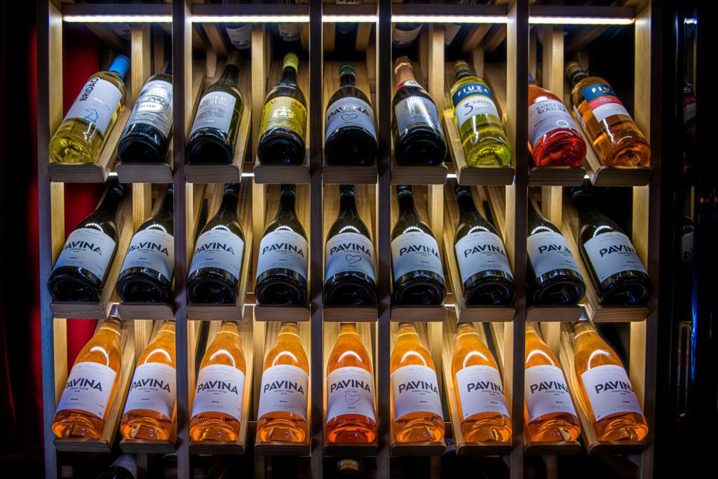 Fontecruz Lisboa an Autograph Collection Hotel, Classic Vintage Hawaii Calling a shelf of wine bottles