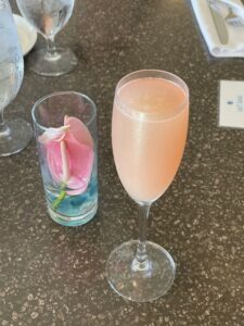 Review & Video: The Royal Hawaiian, Waikiki, A Luxury Collection Hotel Hawaii Calling a glass of pink liquid next to a pink flower in a glass