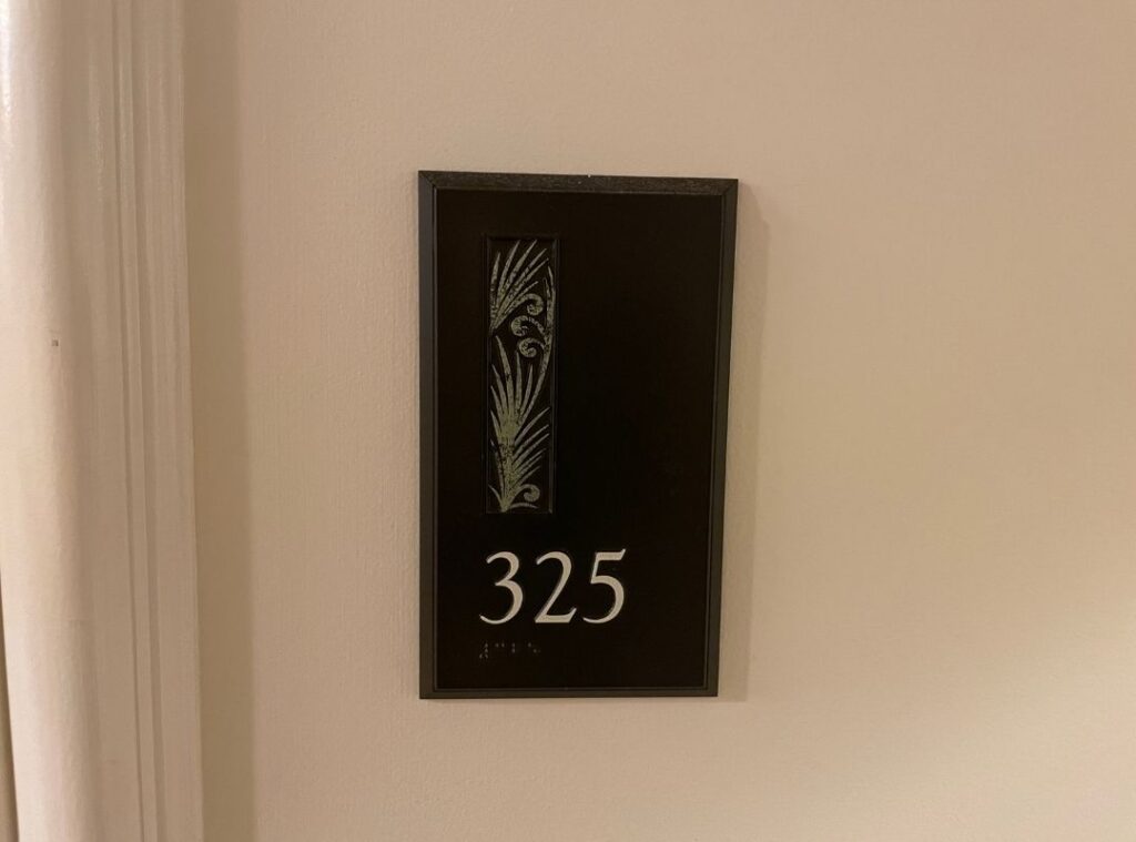 Review & Video: The Royal Hawaiian, Waikiki, A Luxury Collection Hotel Hawaii Calling a black rectangular sign with a number on it
