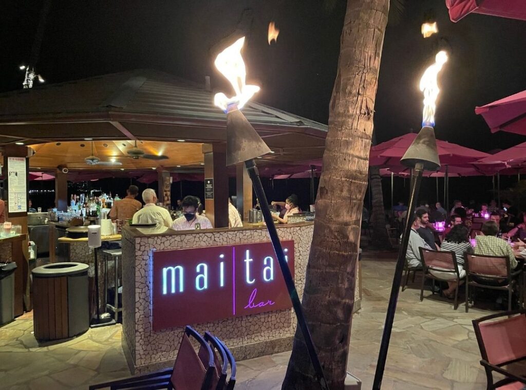 Review & Video: The Royal Hawaiian, Waikiki, A Luxury Collection Hotel Hawaii Calling a bar with a sign and torches