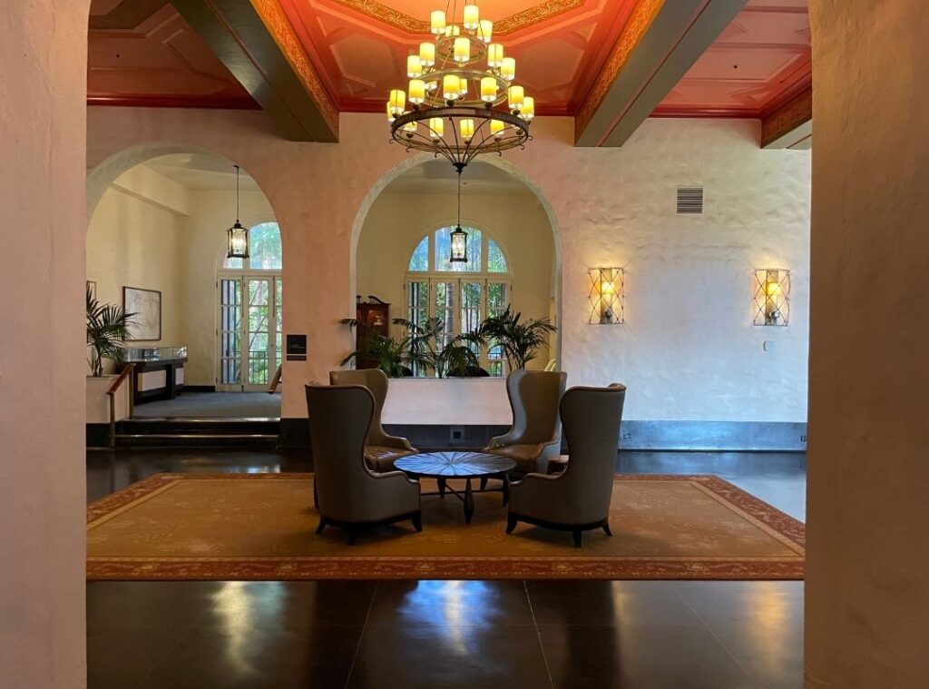 Review & Video: The Royal Hawaiian, Waikiki, A Luxury Collection Hotel Hawaii Calling a room with a chandelier and chairs