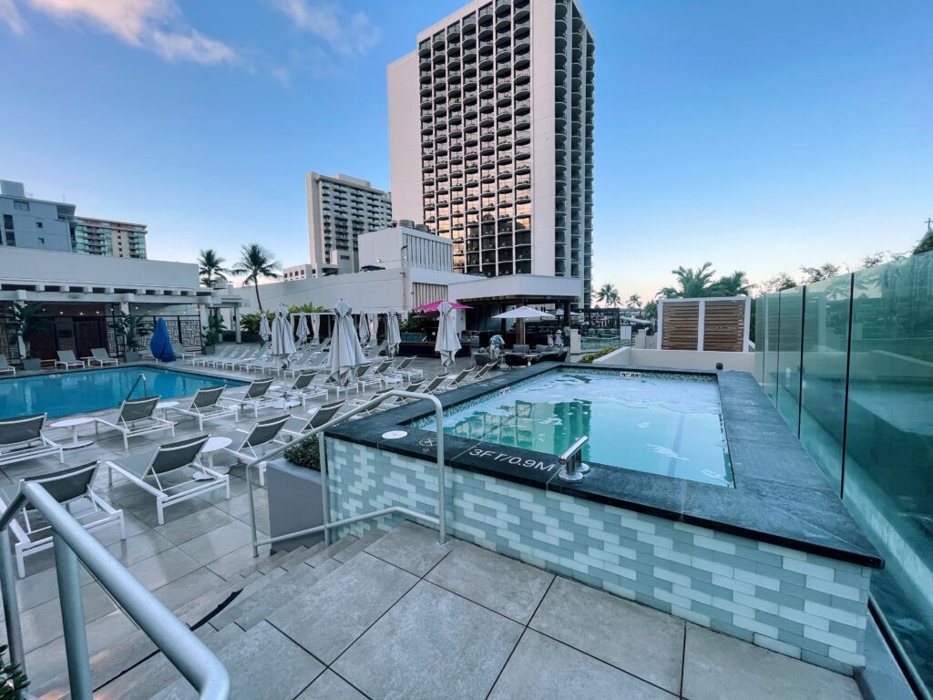 Review & Video: Waikiki Beach Marriott Resort & Spa Hawaii Calling a pool with chairs and umbrellas in a hotel