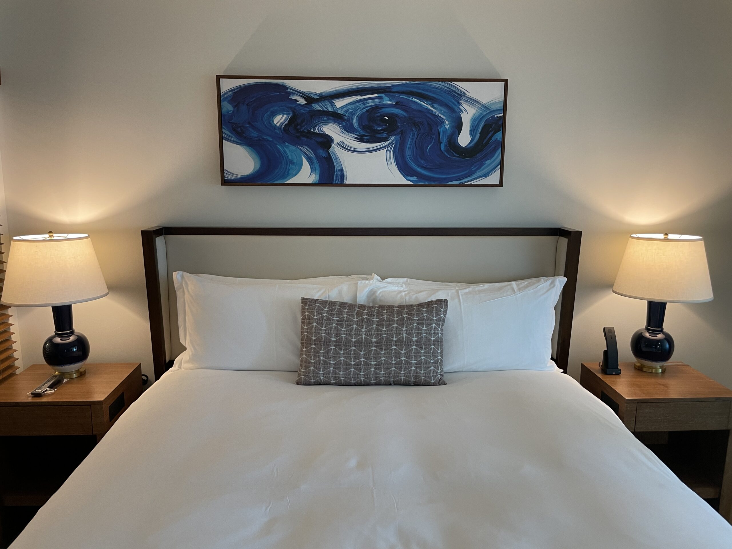 7 Best Luxury Hotels on Oahu (2025) Hawaii Calling a bed with a white bedding and a painting above it
