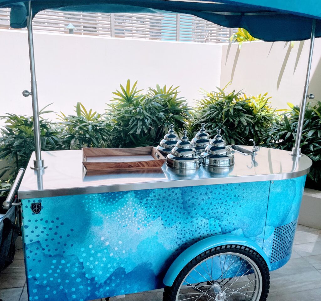 Review & Video: The Ritz-Carlton Waikiki Beach, Luxurious Residences & Hotel Hawaii Calling a blue cart with silver containers on it