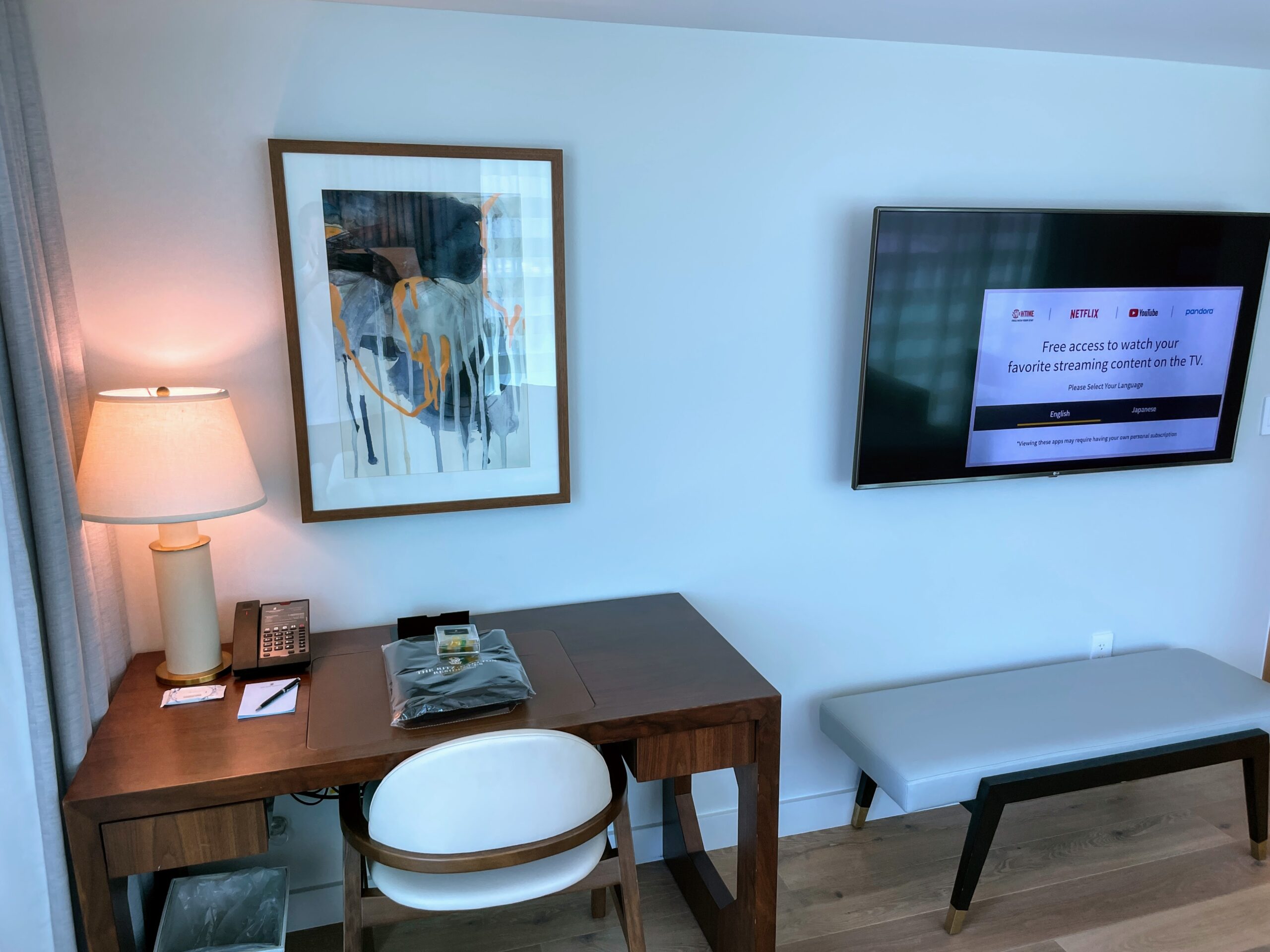 Review & Video: The Ritz-Carlton Waikiki Beach, Luxurious Residences & Hotel Hawaii Calling a desk and chair in a room with a tv on the wall