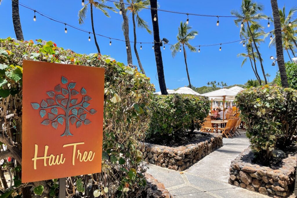 Review & Video: Mauna Kea Beach Hotel, Autograph Collection Hawaii Calling a sign on a sidewalk with trees and chairs