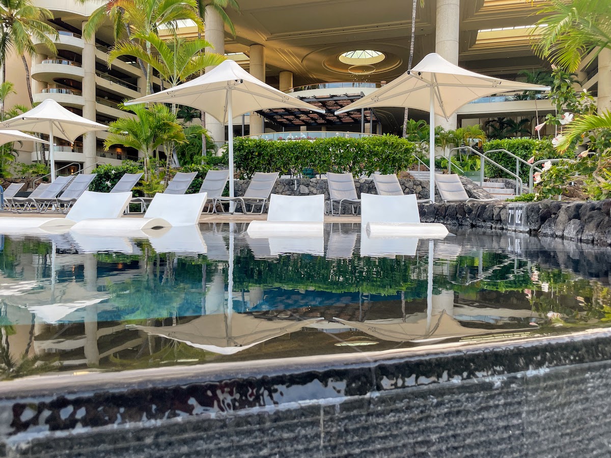 Review & Video: The Westin Hapuna Beach Resort Hawaii Calling a pool with chairs and umbrellas in front of a building