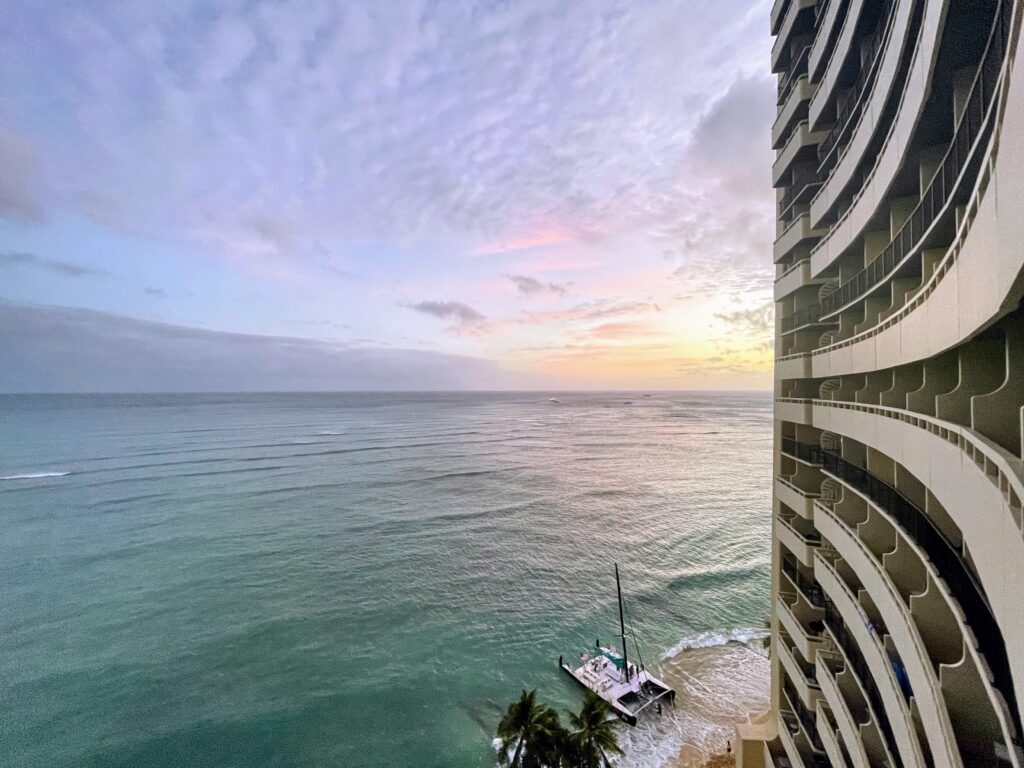 Review & Video: Sheraton Waikiki, Best Family Hotel on Oahu Hawaii Calling a tall building with a boat on the beach