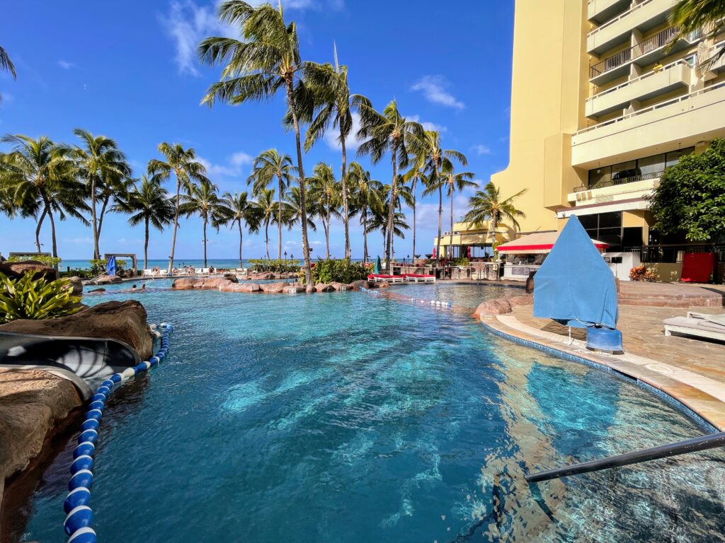 Review & Video: Sheraton Waikiki, Best Family Hotel on Oahu Hawaii Calling a pool with palm trees and a building