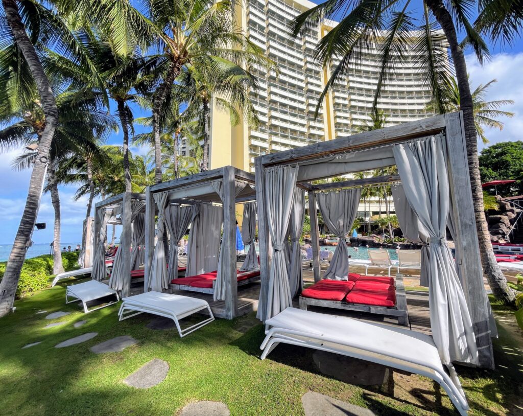 Review & Video: Sheraton Waikiki, Best Family Hotel on Oahu Hawaii Calling a group of beds with red pillows in front of a building