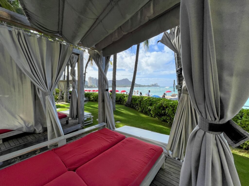 Review & Video: Sheraton Waikiki, Best Family Hotel on Oahu Hawaii Calling a beach with a view of the ocean and a beach with a couple of red beds