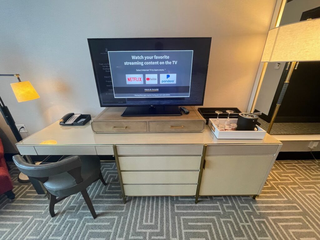 Review & Video: The Ritz-Carlton Washington DC, Refined Luxury Hawaii Calling a tv on a desk