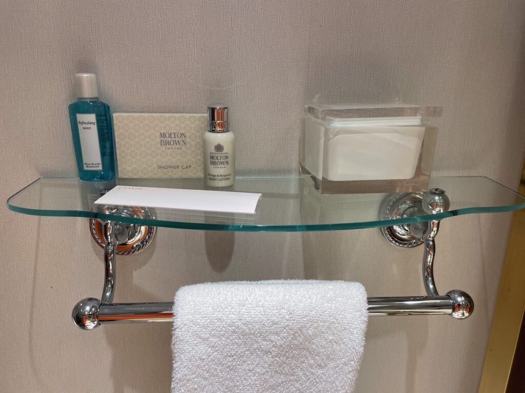Review & Video: The Ritz-Carlton Washington DC, Refined Luxury Hawaii Calling a glass shelf with a towel and a white towel on it