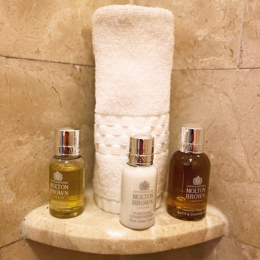 Review & Video: The Ritz-Carlton Washington DC, Refined Luxury Hawaii Calling a group of small bottles of shampoo and a towel on a shelf