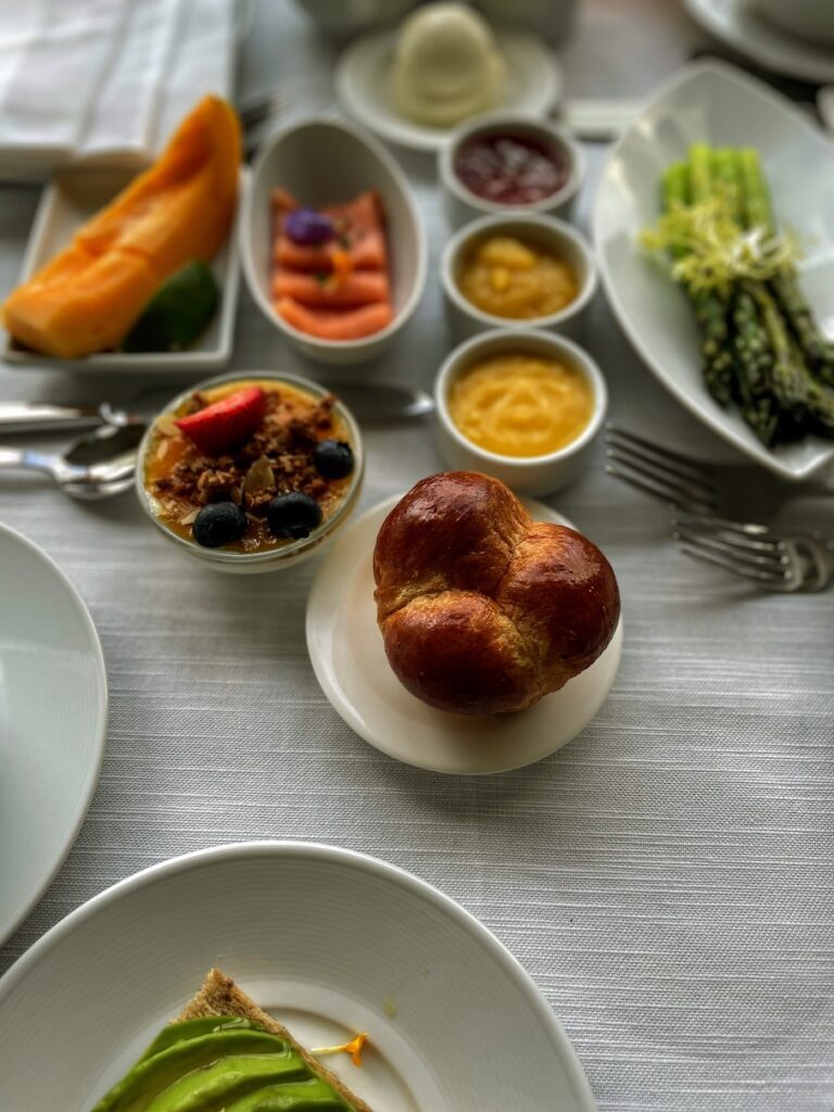 Review & Video: The Kahala Hotel and Resort, Presidential Luxury Hawaii Calling a table with plates of food and a roll on it