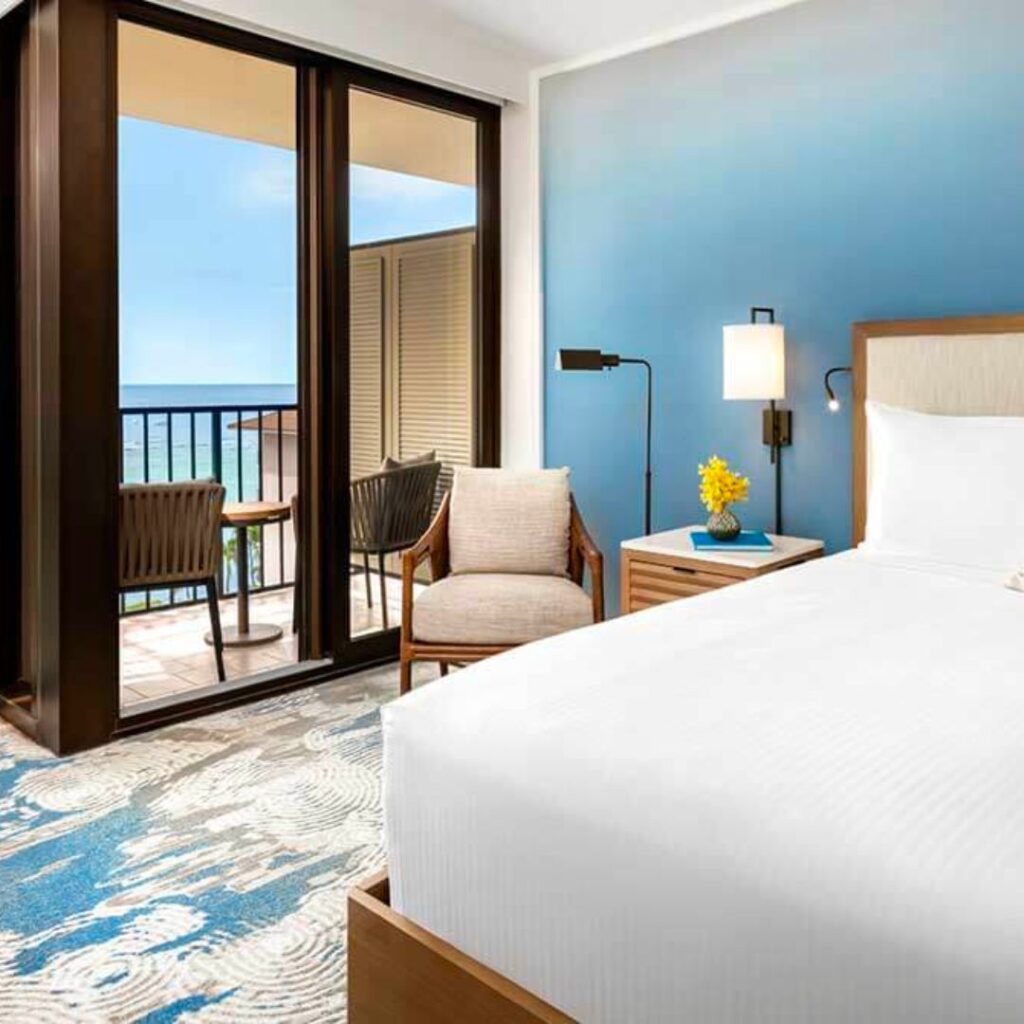 6 Amazing Boutique Hotels on Oahu (2025) Hawaii Calling a bedroom with a balcony and a balcony overlooking the ocean