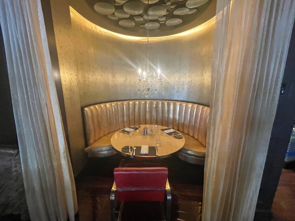 Review & Video: The St. Regis Washington DC, Historic Luxury Hawaii Calling a table with a chandelier and chairs in a booth