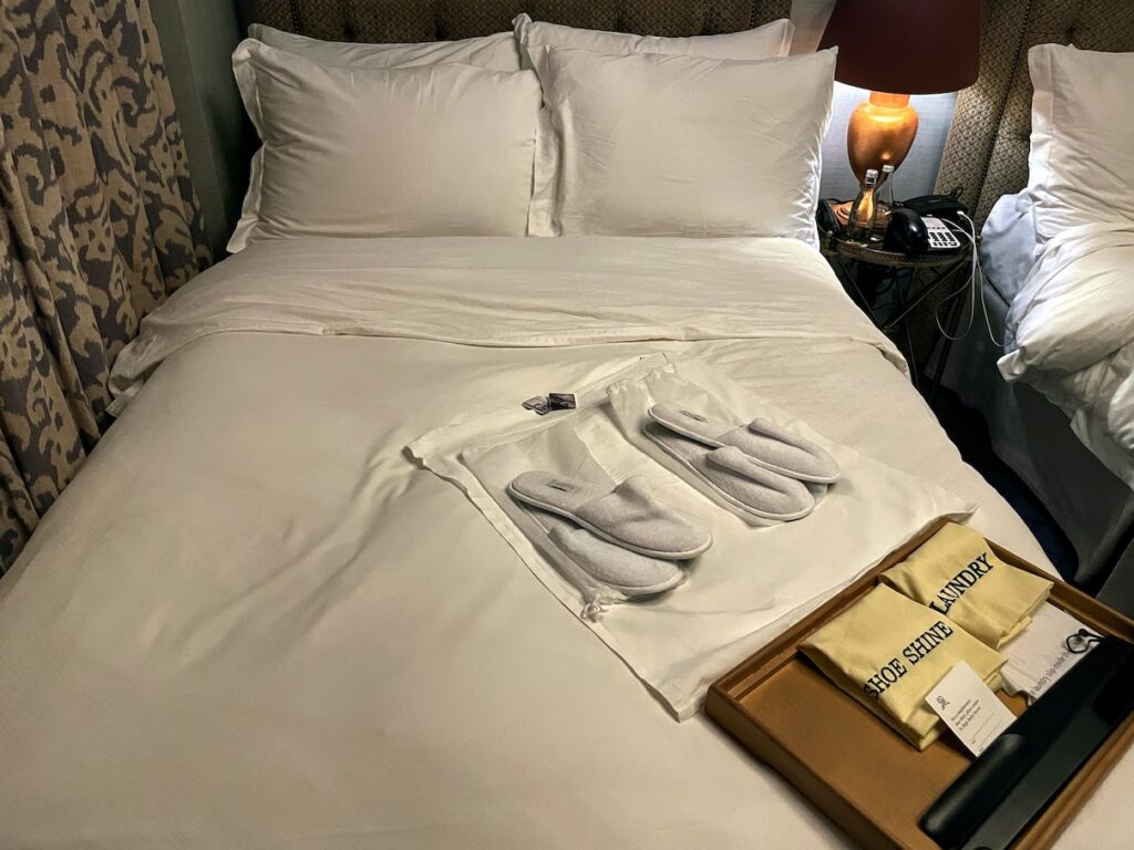 Review & Video: The St. Regis Washington DC, Historic Luxury Hawaii Calling a bed with white sheets and slippers