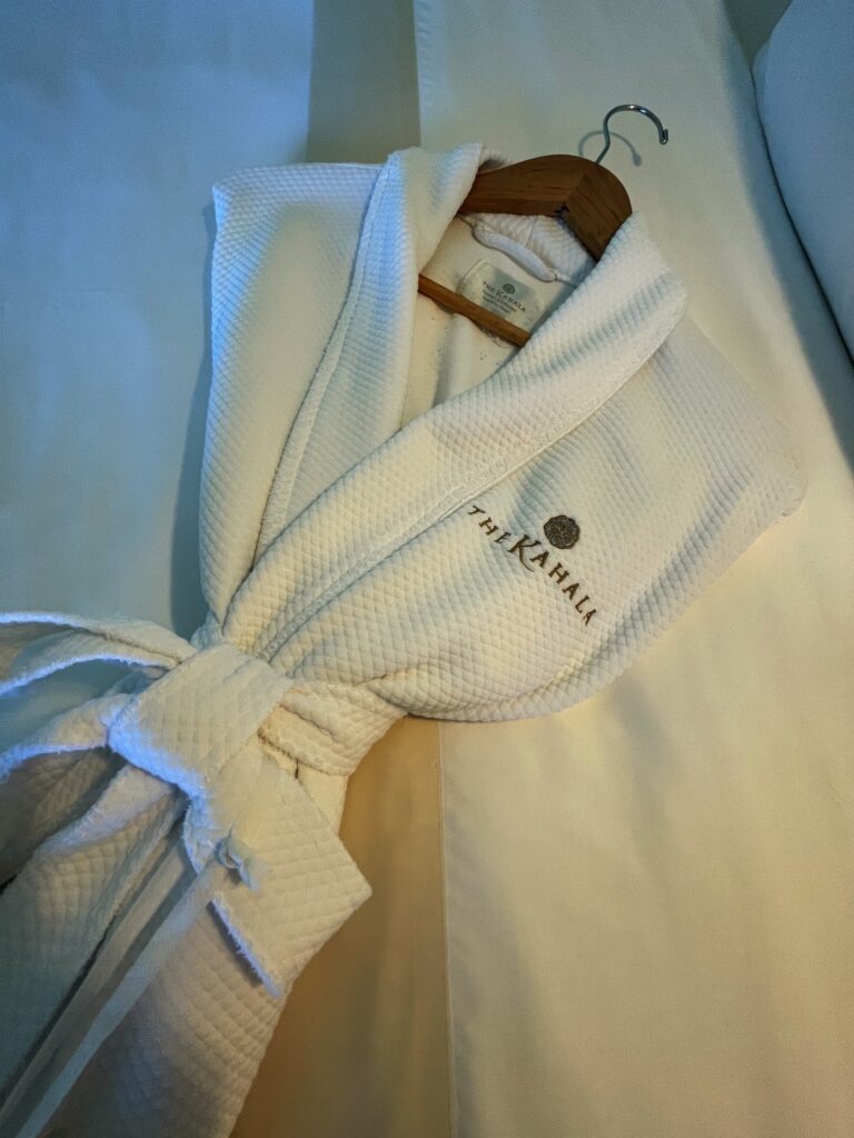12 Plush & Cozy Hotel Robes Of The World Hawaii Calling One of the Kahala Hotel and Resort hotel robes laying on a bed