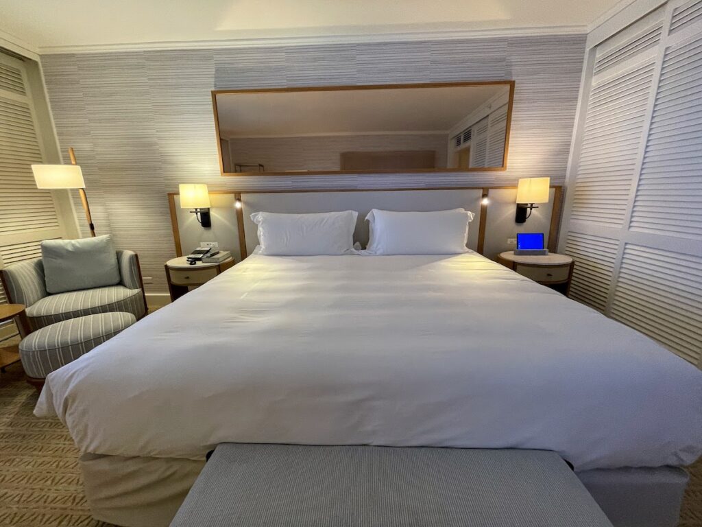 a bed with a mirror above it