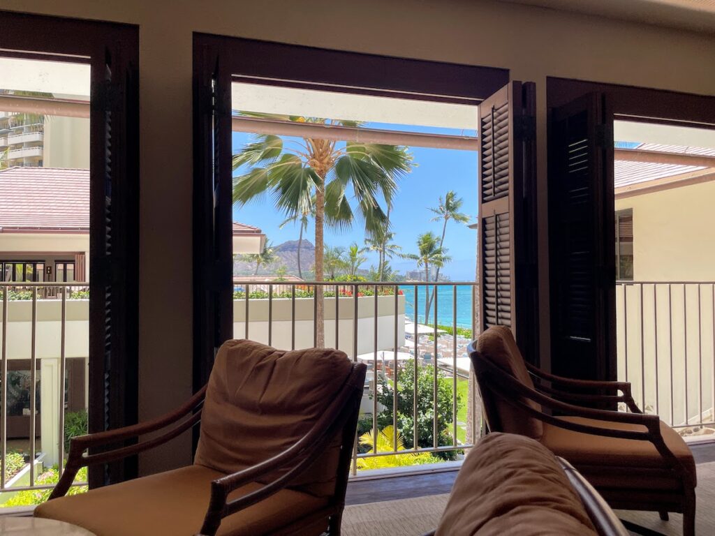 a room with chairs and a view of the ocean