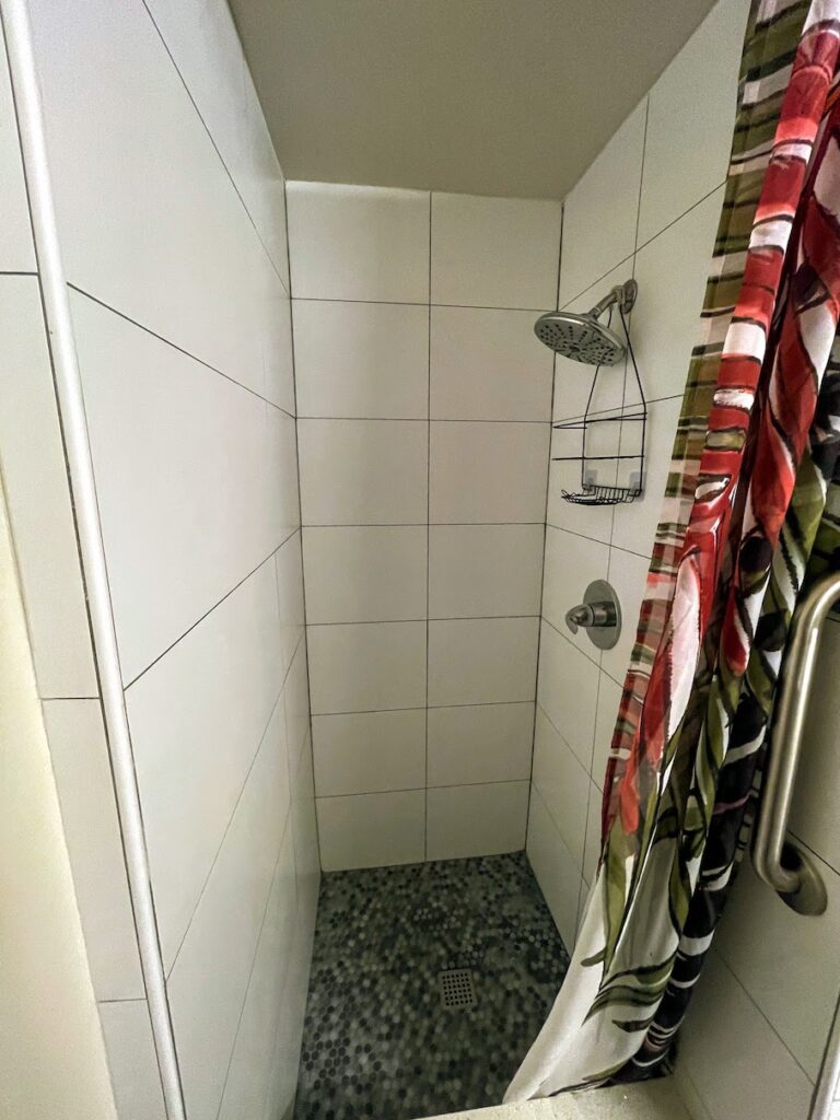 Review & Video: White Sands Hotel, Boutique & Smart Hawaii Calling a shower with a colorful curtain