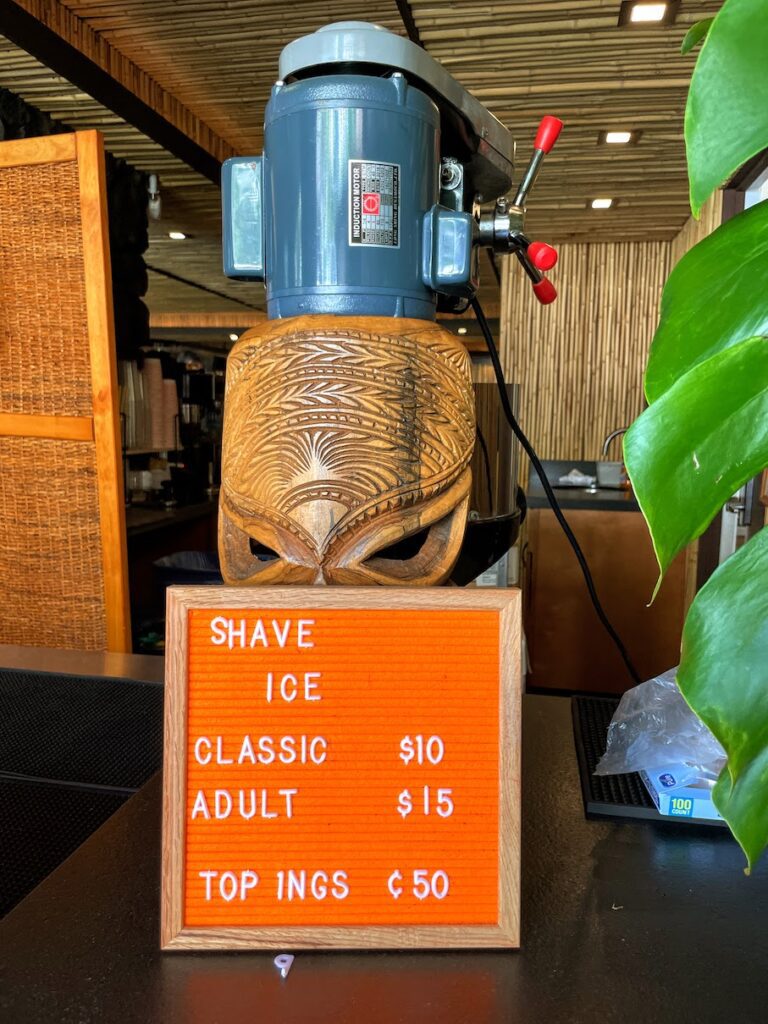 Review & Video: White Sands Hotel, Boutique & Smart Hawaii Calling a sign with a wooden head on a table