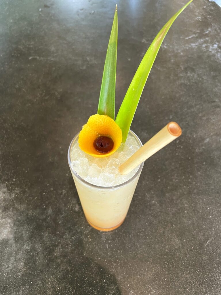 Review & Video: White Sands Hotel, Boutique & Smart Hawaii Calling a glass with a drink and a straw and a lemon slice on top