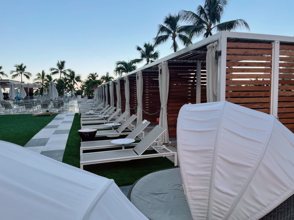 The 15 Best Hotels On Oahu For Families 2025 Hawaii Calling a row of lounge chairs and umbrellas by a pool