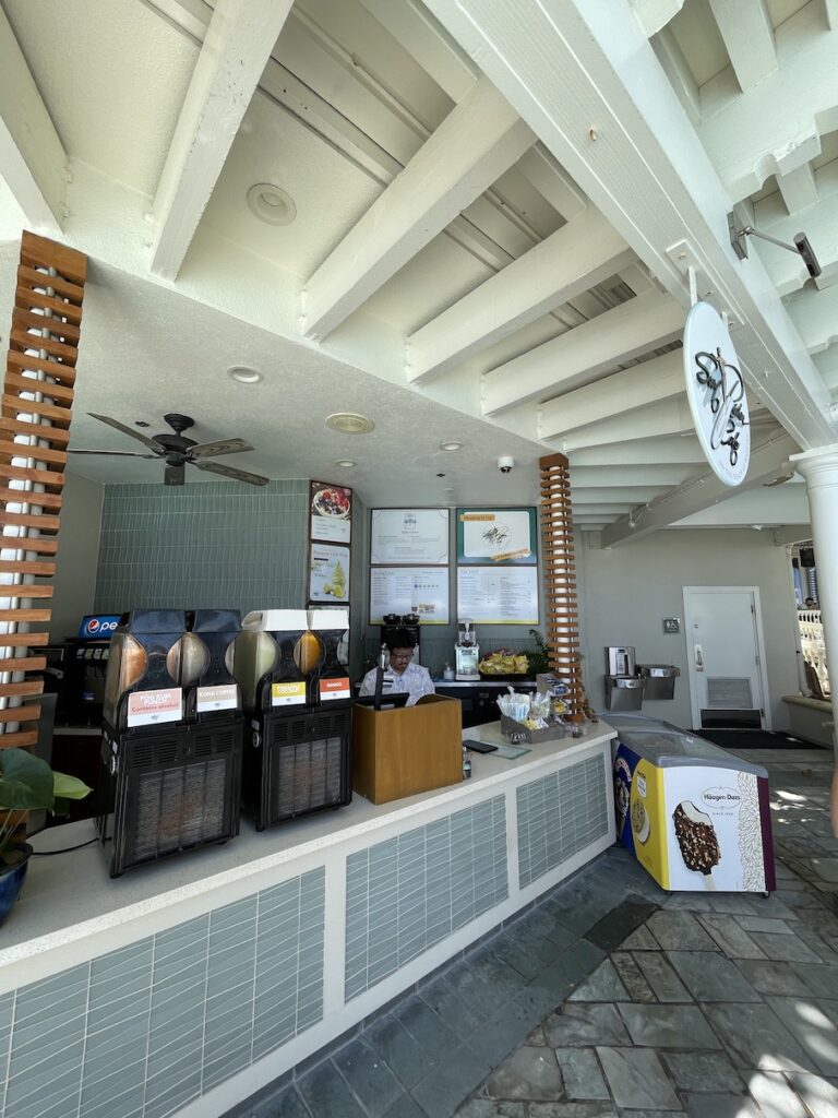 Review & Video: Moana Surfrider, Waikiki Beach Beauty Hawaii Calling a man standing behind a counter