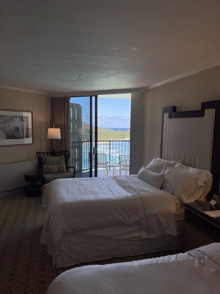 Review & Video: Moana Surfrider, Waikiki Beach Beauty Hawaii Calling a room with a bed and a glass door