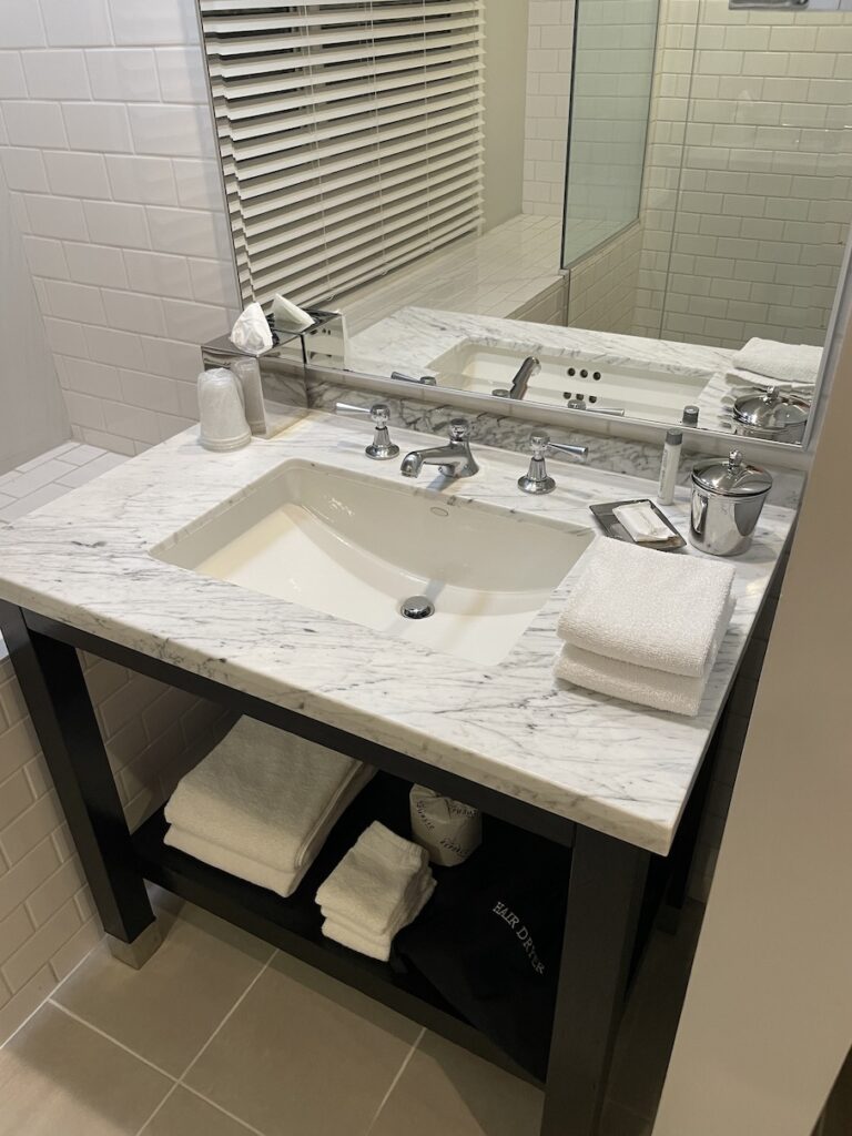 Review & Video: Hotel Republic San Diego, Autograph Collection Hawaii Calling a bathroom with a marble countertop sink and a mirror