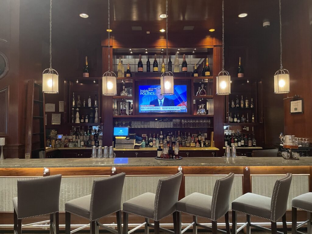 Review & Video: The US Grant, San Diego, a Luxury Collection Hotel Hawaii Calling a bar with chairs and a television in the background