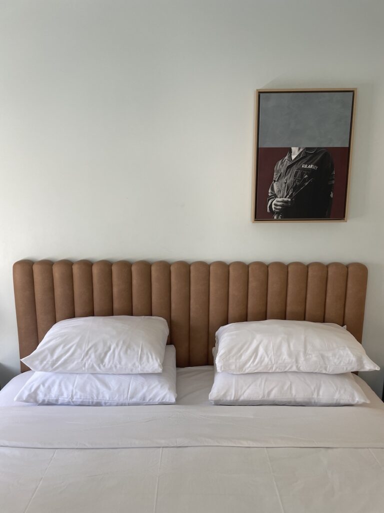 Review & Video: The Guild Hotel, San Diego, a Tribute Portfolio Hotel Hawaii Calling a bed with pillows and a picture on the wall