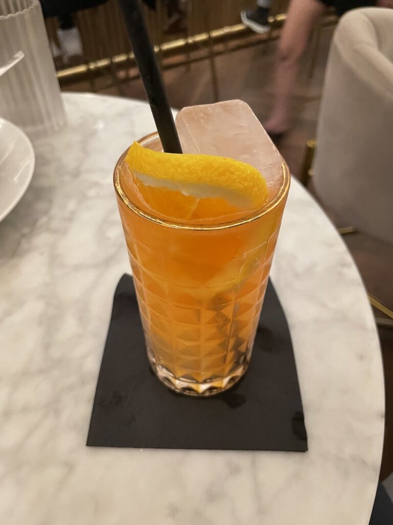 Review & Video: The Guild Hotel, San Diego, a Tribute Portfolio Hotel Hawaii Calling a glass with orange liquid and a straw