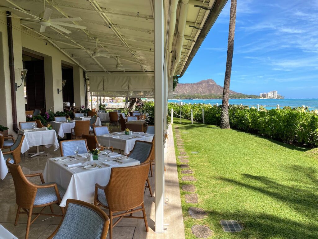 Orchids Breakfast Buffet | Best Brunch In Waikiki Hawaii Calling a restaurant with tables and chairs on a patio