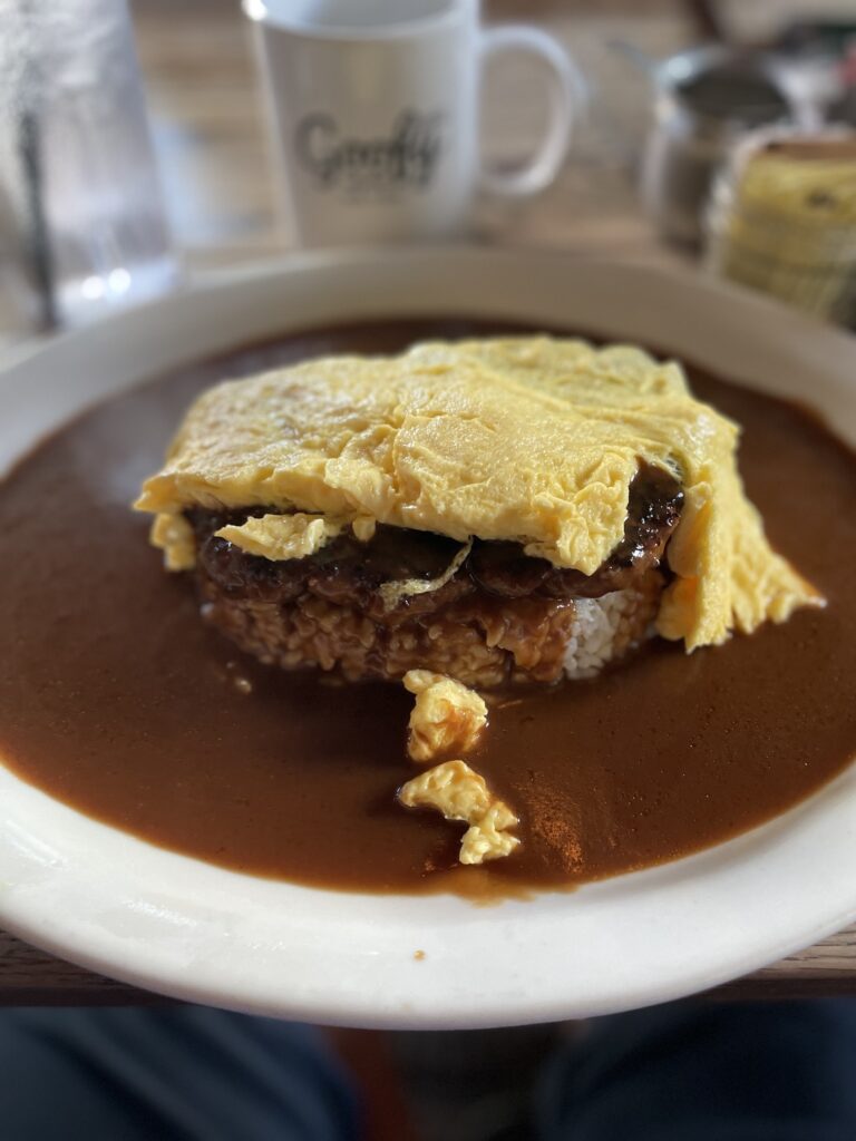 Goofy Cafe & Dine | Breakfast Review Hawaii Calling a plate of food with brown sauce and omelette