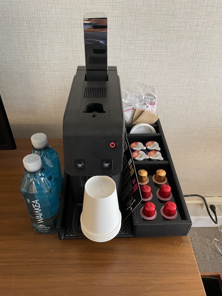 Review & Video: 'Alohilani Resort Waikiki Beach, A Unique Oasis Hawaii Calling a coffee machine with a tray of coffee and drinks
