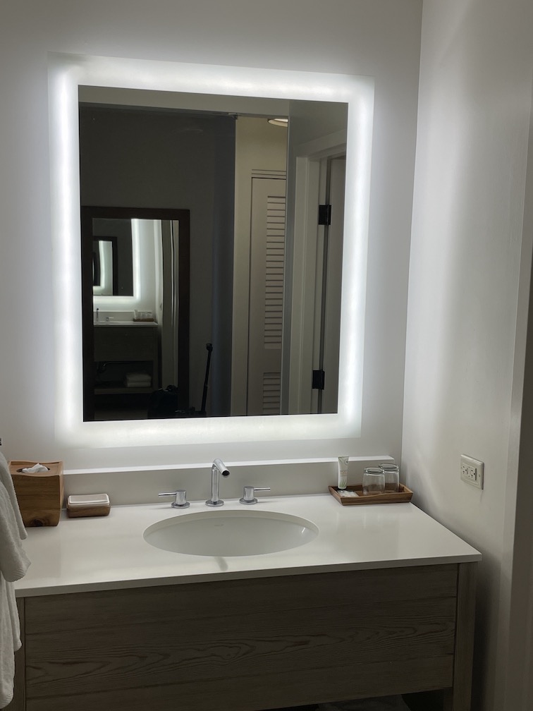 Review & Video: 'Alohilani Resort Waikiki Beach, A Unique Oasis Hawaii Calling a bathroom with a lighted mirror