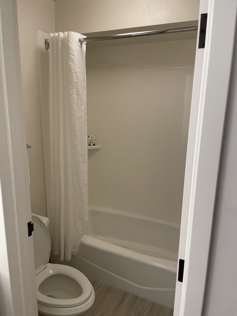 Review & Video: 'Alohilani Resort Waikiki Beach, A Unique Oasis Hawaii Calling a bathroom with a shower curtain