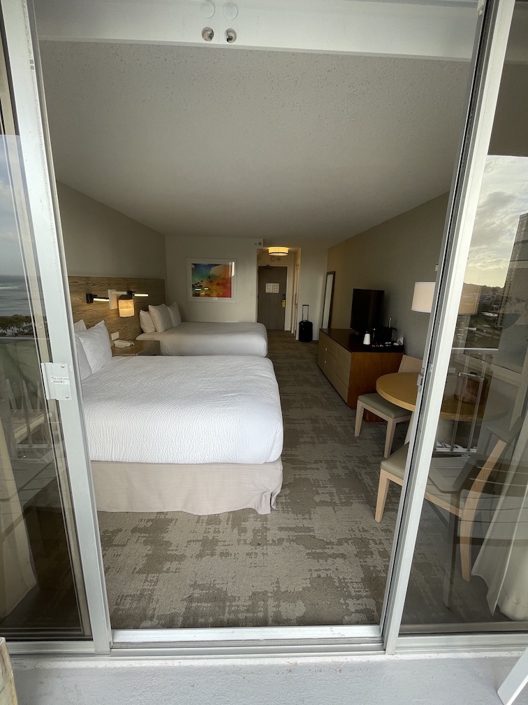 Review & Video: 'Alohilani Resort Waikiki Beach, A Unique Oasis Hawaii Calling a room with two beds and a glass door
