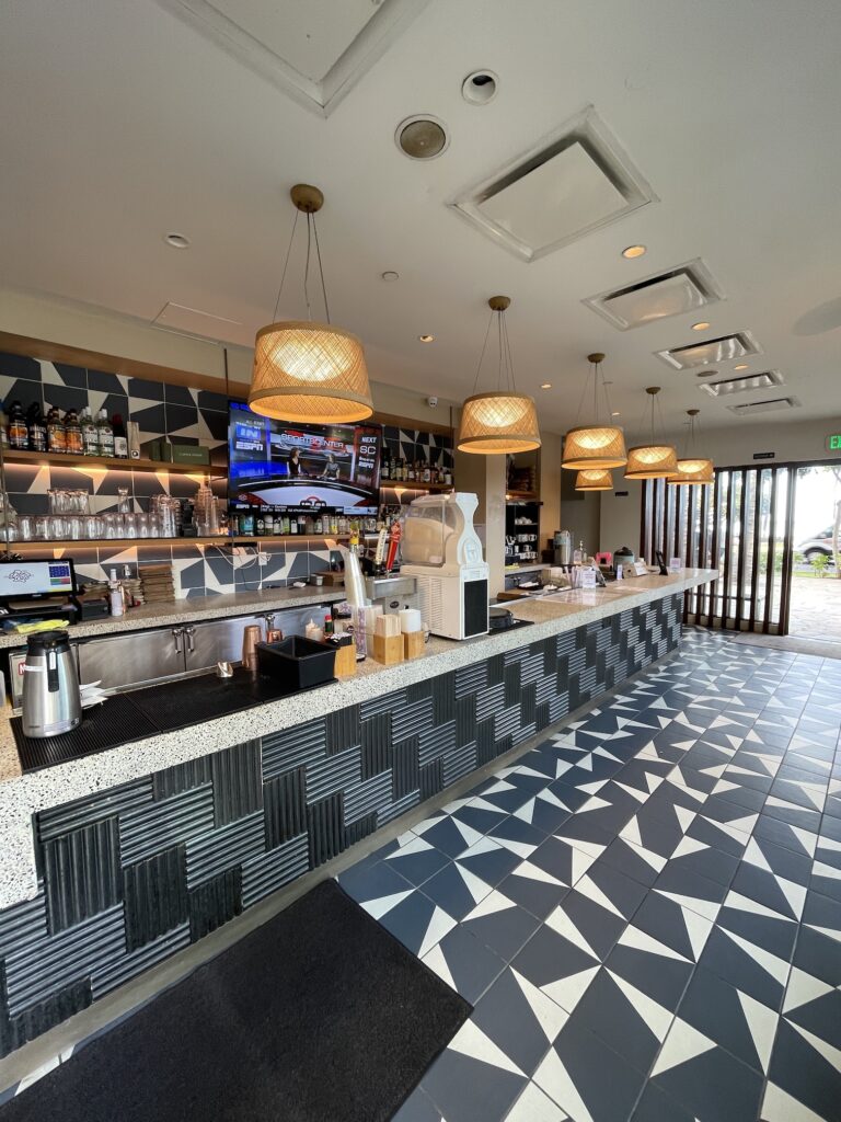 Review & Video: 'Alohilani Resort Waikiki Beach, A Unique Oasis Hawaii Calling a coffee shop with a counter and a tv