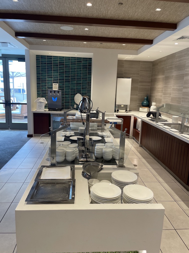 Review & Video: 'Alohilani Resort Waikiki Beach, A Unique Oasis Hawaii Calling a kitchen with a large counter and a large counter with white plates