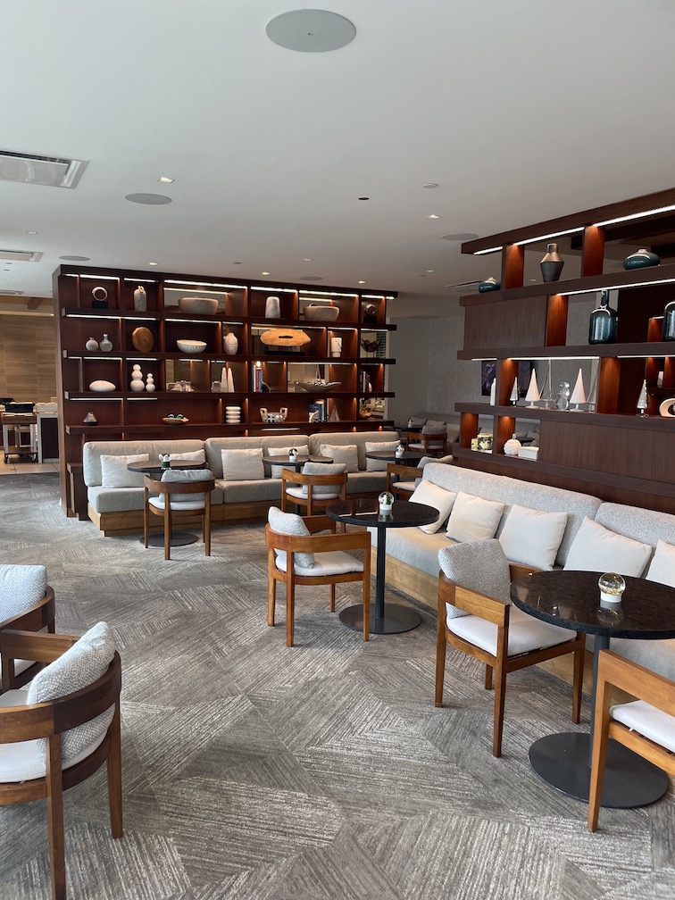 Review & Video: 'Alohilani Resort Waikiki Beach, A Unique Oasis Hawaii Calling a room with a couch and tables and shelves