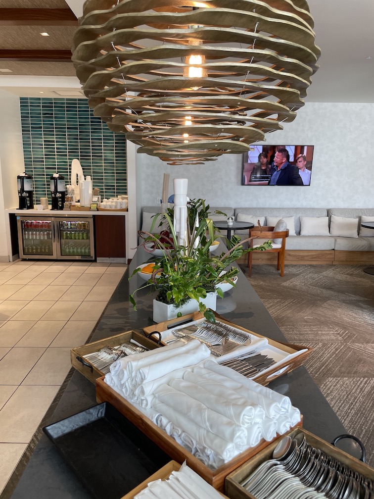 Review & Video: 'Alohilani Resort Waikiki Beach, A Unique Oasis Hawaii Calling a room with a chandelier and a table with a tray of towels