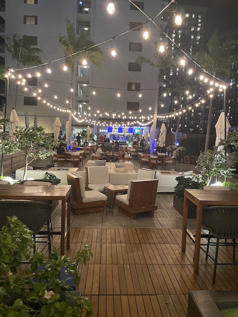 Review & Video: 'Alohilani Resort Waikiki Beach, A Unique Oasis Hawaii Calling a patio with chairs and lights