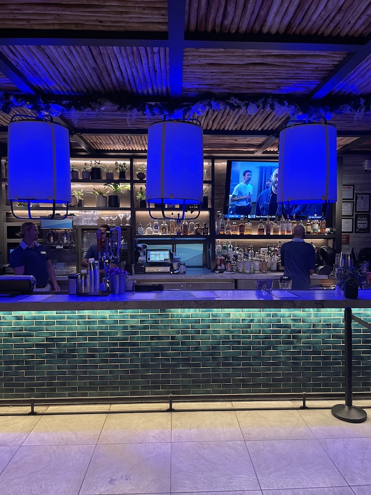 Review & Video: 'Alohilani Resort Waikiki Beach, A Unique Oasis Hawaii Calling a bar with blue lights and a couple of men behind it