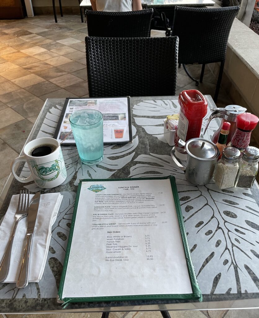 Cinnamon's Ilikai Waikiki | Legendary Breakfast Review Hawaii Calling a table with a menu and a cup of coffee