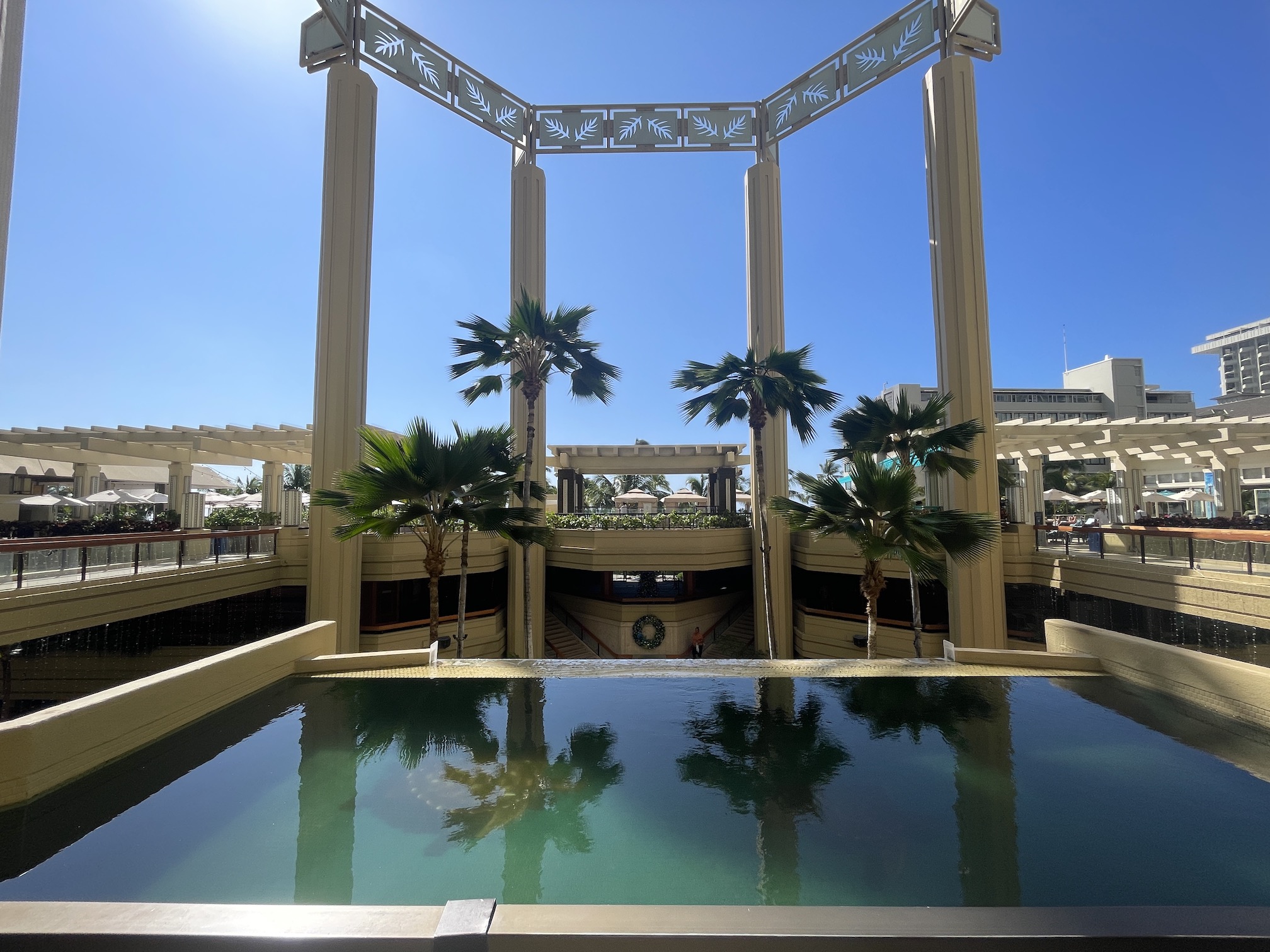 Review: Hyatt Regency Waikiki, Amazing With An Achilles Heel Hawaii Calling a pool with palm trees and a building with a roof