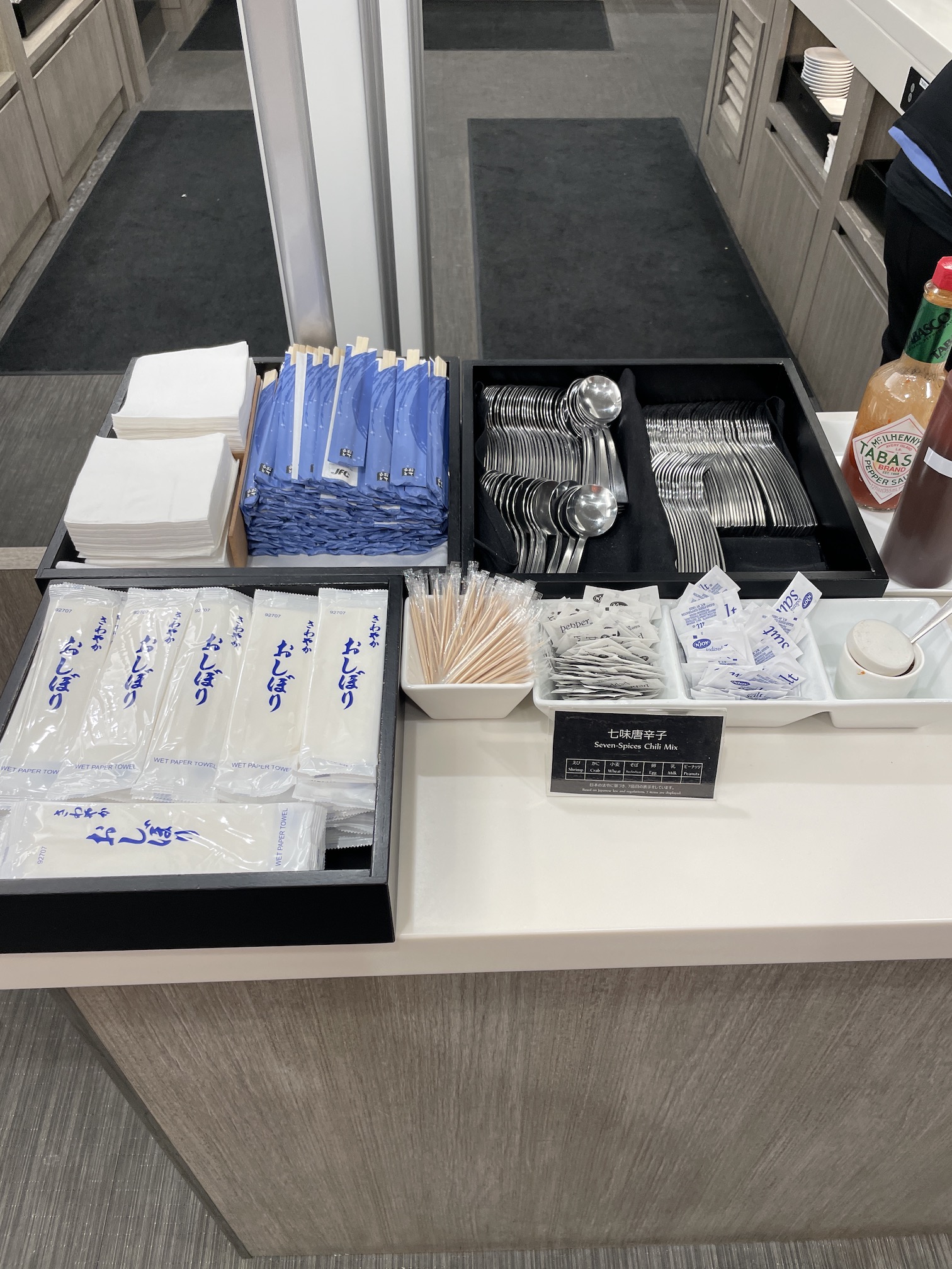 Honolulu Admirals Club | Guide & Review (2025) Hawaii Calling a trays of food and utensils on a counter